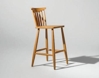 May include: A light-coloured wooden bar stool with a slatted back and a square seat. The stool has four legs and a footrest. The height of the stool is approximately 102 cm.