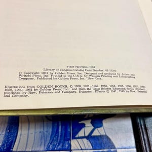 May include: Open book page with text from Golden Press, Inc. The text includes copyright information, Library of Congress Catalog Card Number, and printing details. The page is set against a blue and white tile background.