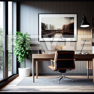 May include: A modern home office with a wooden desk, a black leather office chair, a potted plant, a bookshelf, and a framed photograph of a city skyline.