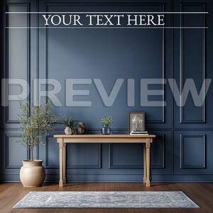 May include: A wooden console table with a light wood finish sits in front of a dark blue wall with white trim. The table has a rectangular top and two legs on each side. There are plants and a framed picture on the table. The wall has a decorative pattern of squares and rectangles. The floor is a light wood color. The text "YOUR TEXT HERE" is written in white on the wall.