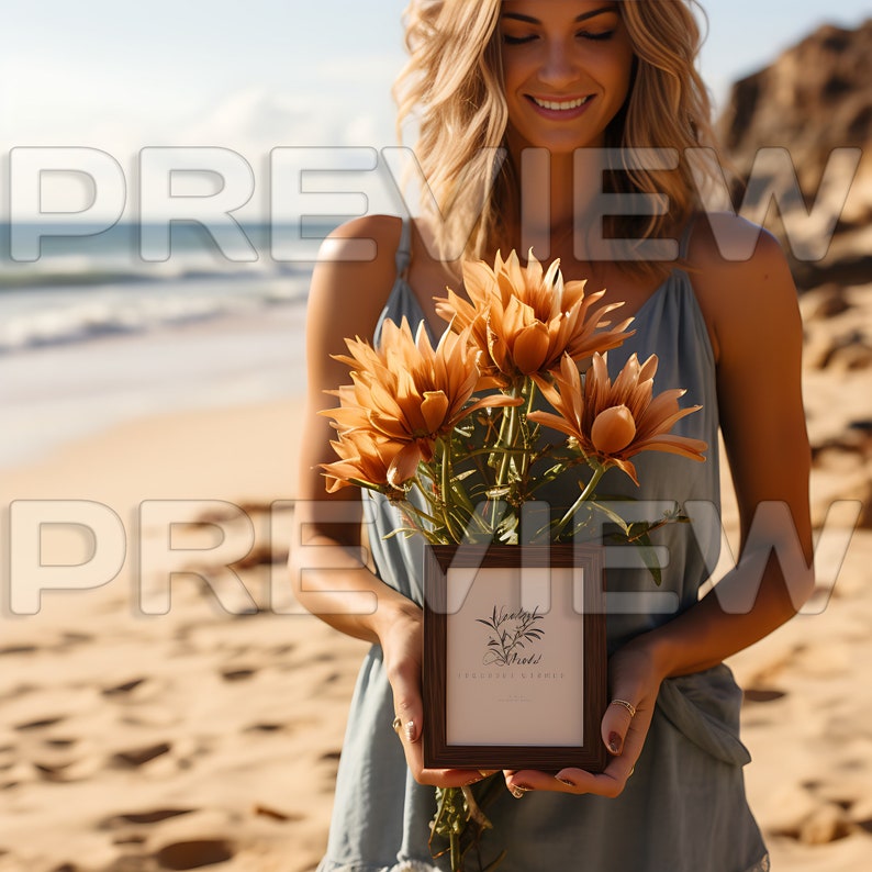 May include: A woman on a beach holds a bouquet of dried flowers and a framed print with the text "Wildly Made" and "Boho Vibes".