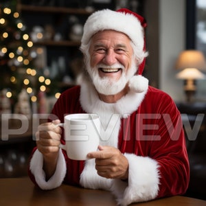 May include: A man dressed as Santa Claus smiles and holds a white mug. He is wearing a red velvet suit with white fur trim and a white Santa hat. A Christmas tree with lights is in the background.