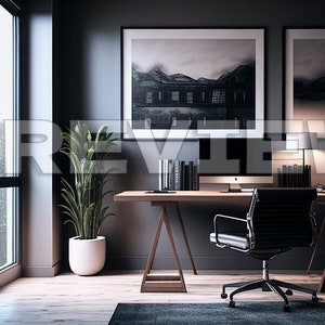 May include: A modern home office with a wooden desk, a black leather office chair, a potted plant, and two black framed photographs on the wall. The desk has a computer monitor, a lamp, and books on it.