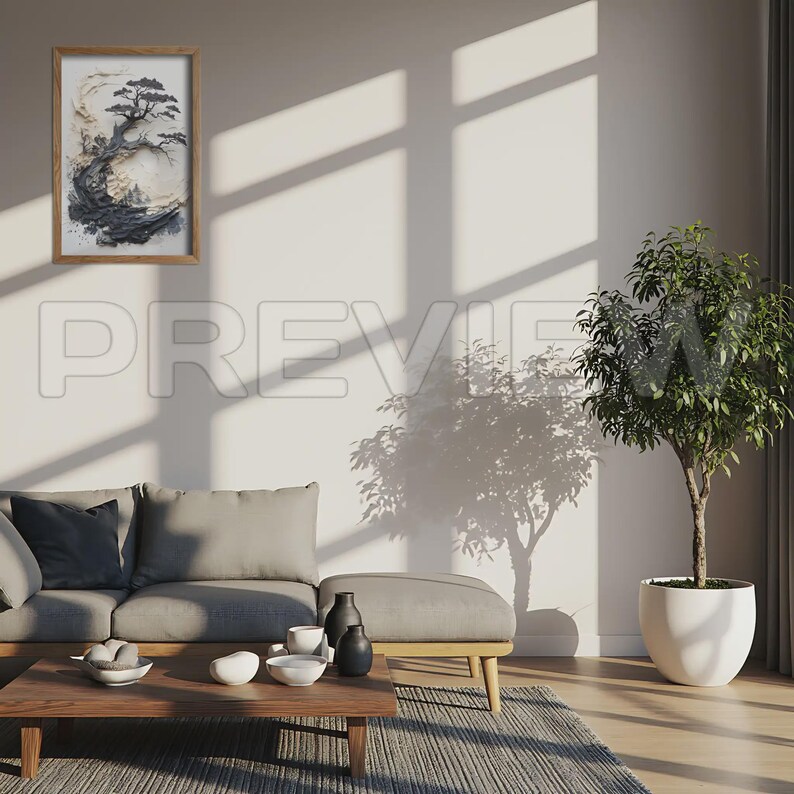 May include: A framed artwork featuring a stylized black and white tree landscape. The artwork is in a wooden frame and hangs on a white wall. The room includes a gray sofa, a wooden coffee table, and a potted plant.