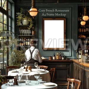 May include: A cozy French restaurant interior with a dark green wall, a wooden bar, and a white table setting. A framed A4 mockup is hanging on the wall.