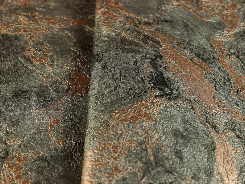 K&ouml;nnte beinhalten: Nahaufnahme eines Stoffes mit Marmorierung in Graut&ouml;nen, Braun und Kupfer. Der Stoff hat eine strukturierte Oberfl&auml;che.