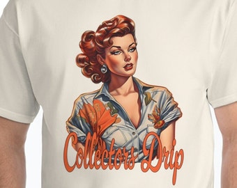 May include: A white t-shirt with a vintage-style illustration of a woman with red hair wearing a blue shirt with orange and brown floral accents. The text "Collectors Drip" is printed in orange below the illustration.
