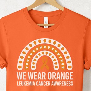 We Wear Orange Leukemia Awareness Shirt | Cancer Support Tee | Orange Ribbon T-Shirt | Leukemia Fighter Survivor Gift | Support Family Shirt