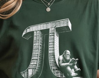 May include: Dark green t-shirt featuring a white graphic of the mathematical symbol Pi, constructed as a building, with a Bigfoot reading a book. The shirt is a comfortable, casual style.