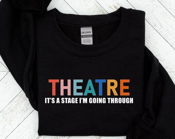 May include: Black sweatshirt with the text "THEATRE IT'S A STAGE I'M GOING THROUGH" in rainbow colors.