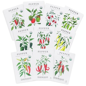 May include: A collection of white seed packets featuring watercolor illustrations of various pepper plants. Each packet displays the pepper type, such as 'Jalapeno' and 'Serrano Tampiqueno', along with the 'Sereniseed' logo and a USDA organic seal.