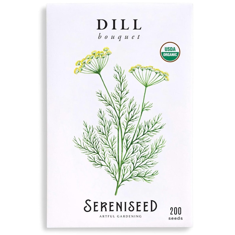 May include: A white seed packet for dill bouquet. The packet features a green and yellow illustration of dill plants. The text "DILL bouquet" is at the top, with "Sereniseed Artful Gardening" and "200 seeds" at the bottom. A USDA Organic seal is on the right.