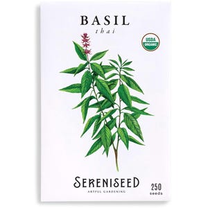 May include: A packet of Thai basil seeds. The white packet features a watercolor illustration of a basil plant with green leaves and small purple flowers. Text includes "BASIL thai", "USDA Organic", "Sereniseed", and "250 seeds".