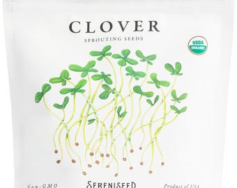 May include: A white bag of clover sprouting seeds. The bag features a watercolor illustration of clover sprouts with green leaves and yellow stems. Text on the bag includes "CLOVER," "SPROUTS," "SERENISEED," and "Net WT: 16 oz."