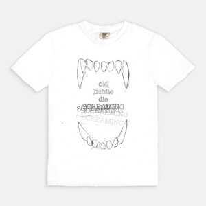 May include: White t-shirt with a black and white graphic of a set of teeth and the text "old habits die screaming screaming screaming"