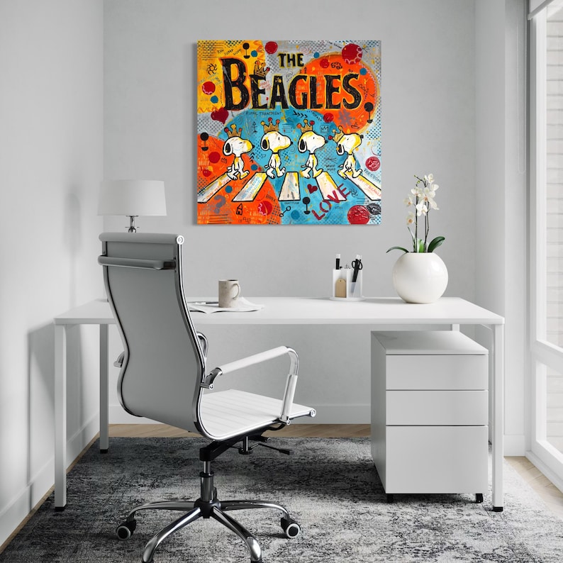 May include: A colorful pop art painting titled "The Beagles" depicts Snoopy and his friends crossing a street, a parody of the Beatles' Abbey Road album cover. The artwork features vibrant orange, blue, and yellow hues.