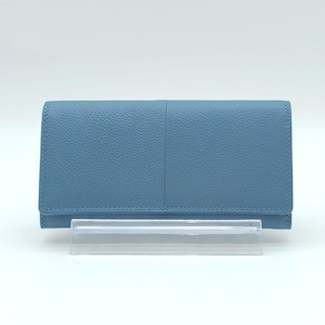 May include: A light blue leather wallet with a textured surface. The wallet has a bi-fold design with a flap closure. The wallet is displayed on a clear plastic stand against a white background.