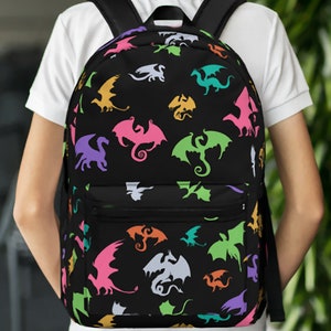 May include: A black backpack with a colorful dragon pattern. The dragons are in various shades of pink, green, blue, and yellow.