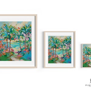 May include: Three framed prints of a tropical scene with palm trees, a blue body of water, and a path leading to the water. The prints are in different sizes, with the largest print on the left and the smallest print on the right.