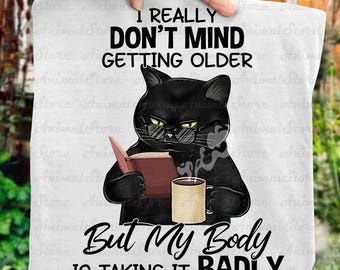 Funny Cat T-Shirt – “I Don’t Mind Getting Older But My Body Is Taking It Badly” Tee, Cat Lover Shirt, Coffee & Book Cat Tshirt, Humor Gift
