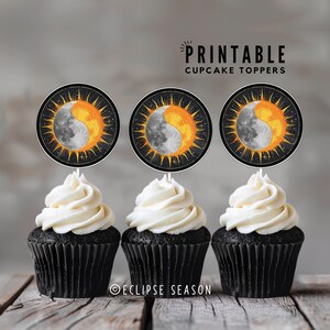 May include: Printable cupcake toppers featuring a black and white illustration of a sun and moon with a yellow and orange sun. The text "PRINTABLE CUPCAKE TOPPERS" is at the top of the image. The text "ECLIPSE SEASON" is at the bottom of the image.