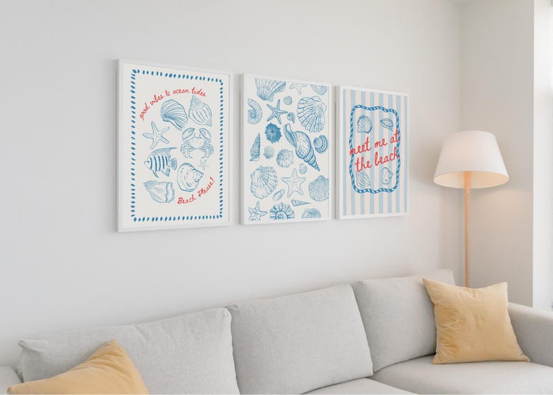 May include: Three framed art prints with a beach theme. Each print features blue illustrations of seashells, starfish, and marine life on a white background. One print has text that says "meet me at the beach".