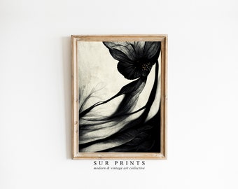 May include: A black and white botanical illustration of a flower with a dark center and delicate petals. The image is framed in a light wood frame.