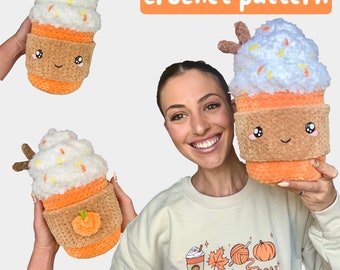 May include: A crochet pattern for a cute pumpkin spice latte cup with a white whipped cream topping and a brown rim. The cup has a smiling face and is holding a small pumpkin. The pattern is available in English and French.