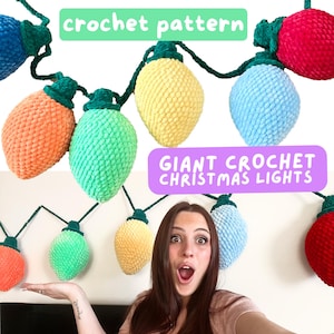 May include: A string of giant crocheted Christmas lights in various colors, including red, blue, green, yellow, and orange. The lights are hanging from a white wall. The text "Giant Crochet Christmas Lights" is visible in the image.