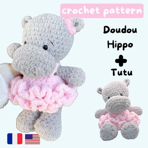 May include: Crochet pattern for a gray hippopotamus wearing a pink tutu. The pattern includes instructions for both the hippo and the tutu. The pattern is available in both English and French.