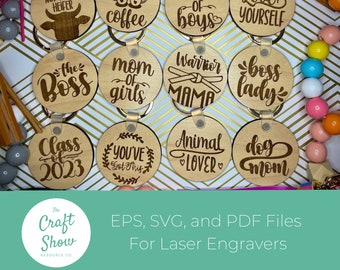 May include: Twelve round wooden keychains with laser engraved text. The keychains feature phrases like "Not Today Heifer", "But First Coffee", "Mom of Boys", "Love Yourself", "The Boss", "Mom of Girls", "Warrior Mama", "Boss Lady", "Class of 2023", "You've Got This", "Animal Lover", and "Dog Mom".