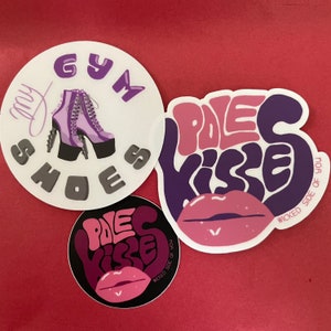 May include: Three round stickers with a purple and pink design. The stickers feature the text "Pole Kisses" and a purple shoe with the text "My Gym Shoes".