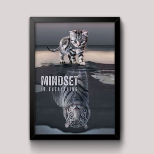 May include: A motivational poster with a black frame featuring a gray and white kitten standing on a reflective surface. The kitten's reflection is a white tiger with the text "MINDSET IS EVERYTHING" below it.