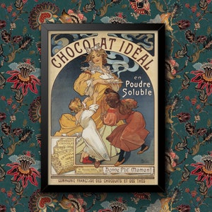 May include: A framed vintage poster advertising Chocolat Ideal. The image shows a woman in a yellow dress serving chocolate to children. Text includes "CHOCOLAT IDEAL" and "en Poudre Soluble". The frame is black, set against a floral patterned background.