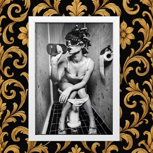 Funny retro-style bathroom photo – woman with curlers and sunglasses drinking on toilet, black and white wall art