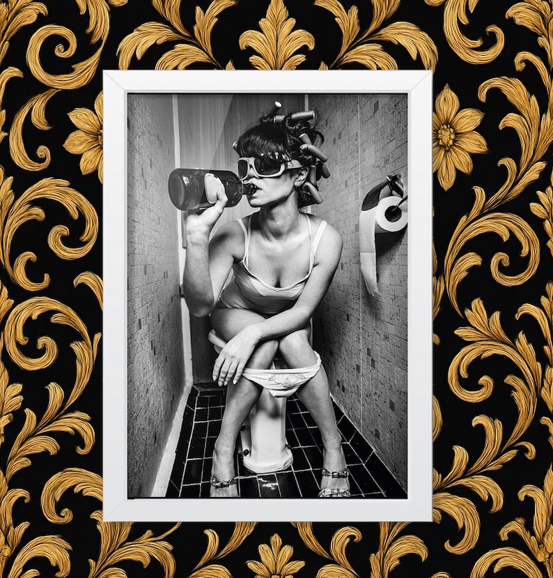 Funny retro-style bathroom photo – woman with curlers and sunglasses drinking on toilet, black and white wall art