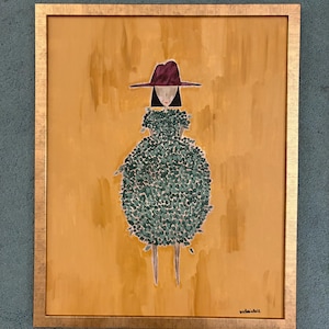 Puede incluir: Obra de arte enmarcada que presenta una figura estilizada con un sombrero burdeos y un vestido verde y frondoso. La figura se alza sobre un fondo amarillo mostaza, enmarcada en oro. La obra tiene un estilo artístico y caprichoso.