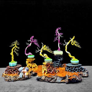 May include: A collection of miniature bonsai trees with vibrant yellow, pink, and green foliage. Each tree is potted in a small ceramic container and displayed on a decorative wooden stand. A small figurine of a couple is also present.