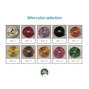 May include: Ten different colors of wire, each wrapped in a circle, are displayed in a grid. The colors are silver, red, purple, black, copper, gold, brown, yellow, pink, and green. The wire is labeled with numbers 1 through 10.