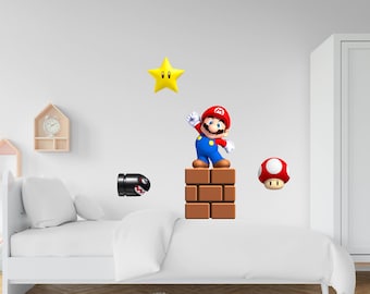 May include: A wall decal set featuring Mario, a yellow star, a black bullet bill, a red mushroom, and a brick block. The decals are on a white wall in a room with a white bed and a white door.