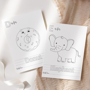 May include: Two white cards with black line drawings. One card says "D is for Donut" with a cartoon donut illustration. The other card says "E is for Elephant" with a cartoon elephant illustration. Both cards have the words "With love" at the bottom.