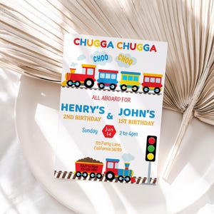 May include: A colorful train-themed birthday invitation for Henry's 2nd birthday and John's 1st birthday. The invitation features a cartoon train with red, yellow, and blue cars, a red stop sign, and a green traffic light. The text reads "Chugga Chugga Choo Choo", "All Aboard for Henry's & John's 2nd Birthday & 1st Birthday", "Sunday Jun 14 2 to 4pm", "123 Party Lane, California 56789", and "RSVP to Mom 123-456-7890".