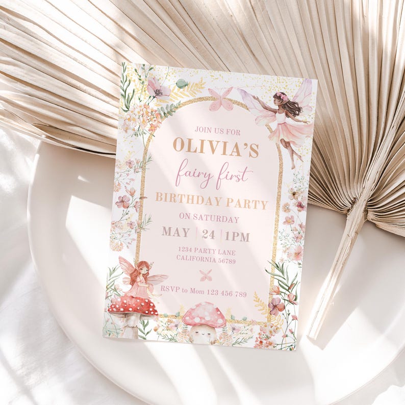 May include: A pink and gold fairy-themed birthday party invitation with a floral design. The invitation says "Join us for Olivia's fairy first birthday party on Saturday, May 24, 1 PM. 1234 Party Lane, California 56789. RSVP to Mom 123 456 789."