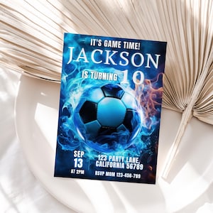 May include: A blue and orange birthday invitation with a soccer ball in flames. The invitation says "It's game time! Jackson is turning 10".