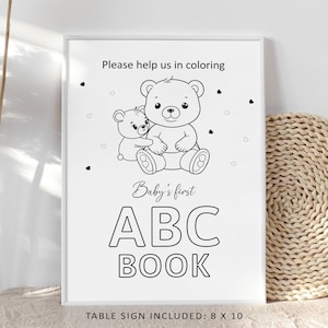 May include: A framed black and white sign with the text "Please help us in coloring" and "Baby's first ABC BOOK". The sign features illustrations of two teddy bears and small hearts. The sign measures 8 x 10 inches.