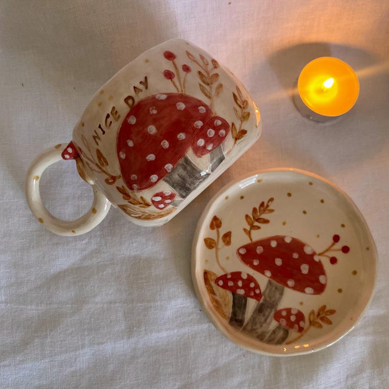 handmade mushroom mug
• whimsical ceramic cup
• toadstool mug
• fairy forest mug
• fantasy pottery
• nature inspired mug
• red mushroom cup
• sculptural handle mug
• cottagecore ceramic
• fungi mug
• handmade tea mug
• forestcore kitchenware
• unique ceramic art