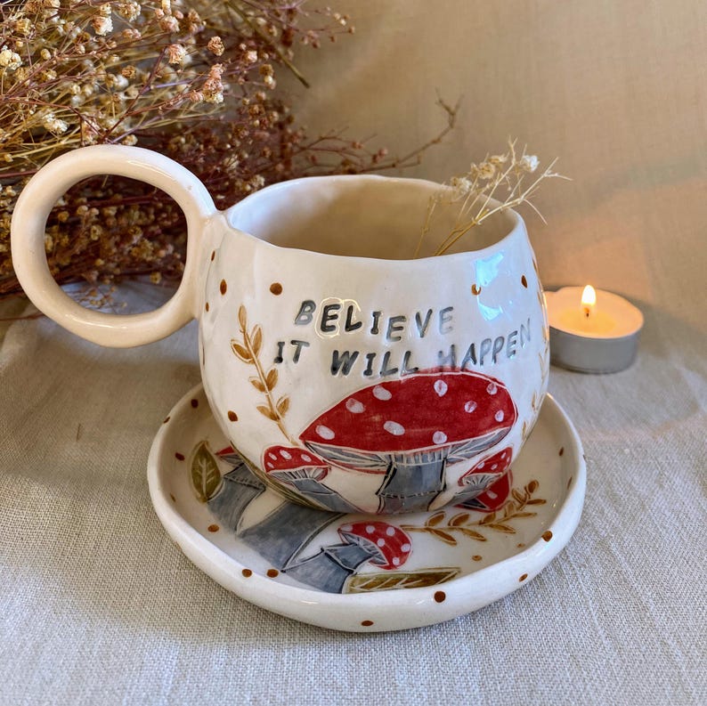 handmade mushroom mug
• whimsical ceramic cup
• toadstool mug
• fairy forest mug
• fantasy pottery
• nature inspired mug
• red mushroom cup
• sculptural handle mug
• cottagecore ceramic
• fungi mug
• handmade tea mug
• forestcore kitchenware
• unique ceramic art