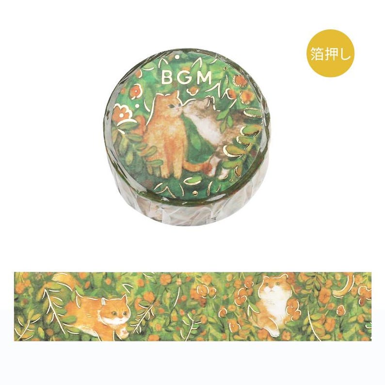 May include: A roll of decorative tape featuring a design of two cats in a garden setting, with the word "BGM" visible. The tape is surrounded by green foliage and orange flowers. A strip of the tape shows the repeating pattern.