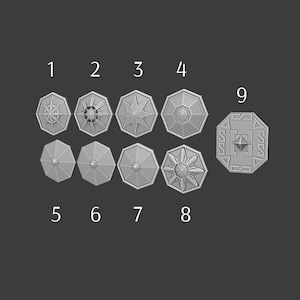 May include: Nine grey, octagonal shield designs are arranged on a dark grey background. Each shield features a unique embossed pattern, including stars, geometric shapes, and floral designs. The shields are numbered 1 through 9.