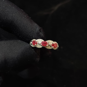 May include: A white ceramic mug with a black handle and the text "But First, Coffee" in a bold, black font. The mug is set against a neutral background, highlighting its simple design.